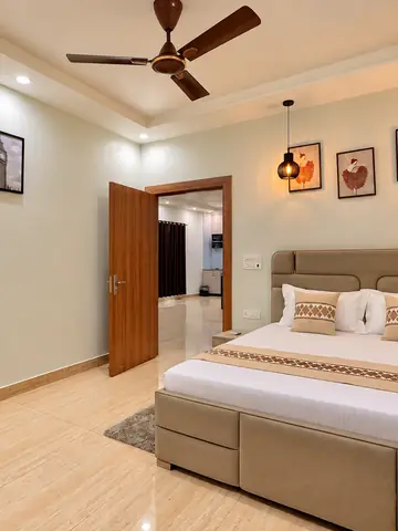 Double bed in bedroom three at Mulberry Farm, Noida