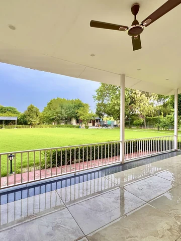 Hedged lawn in front of the farmhouse at Mulberry Farm, Noida