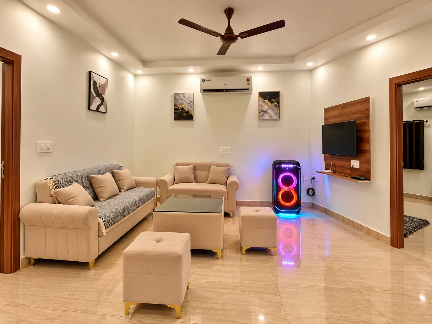 Living room at Mulberry Farm farmhouse, Noida, with sofas and JBL PartyBox