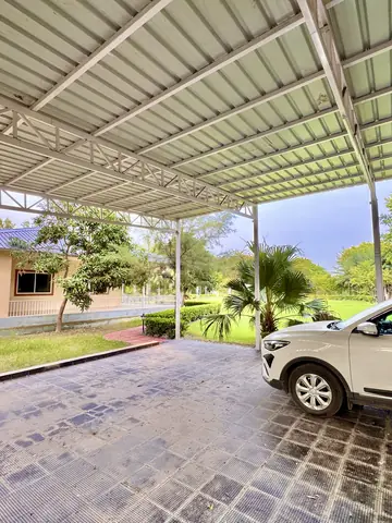 View from the covered parking towards the lawn at Mulberry Farm, Noida
