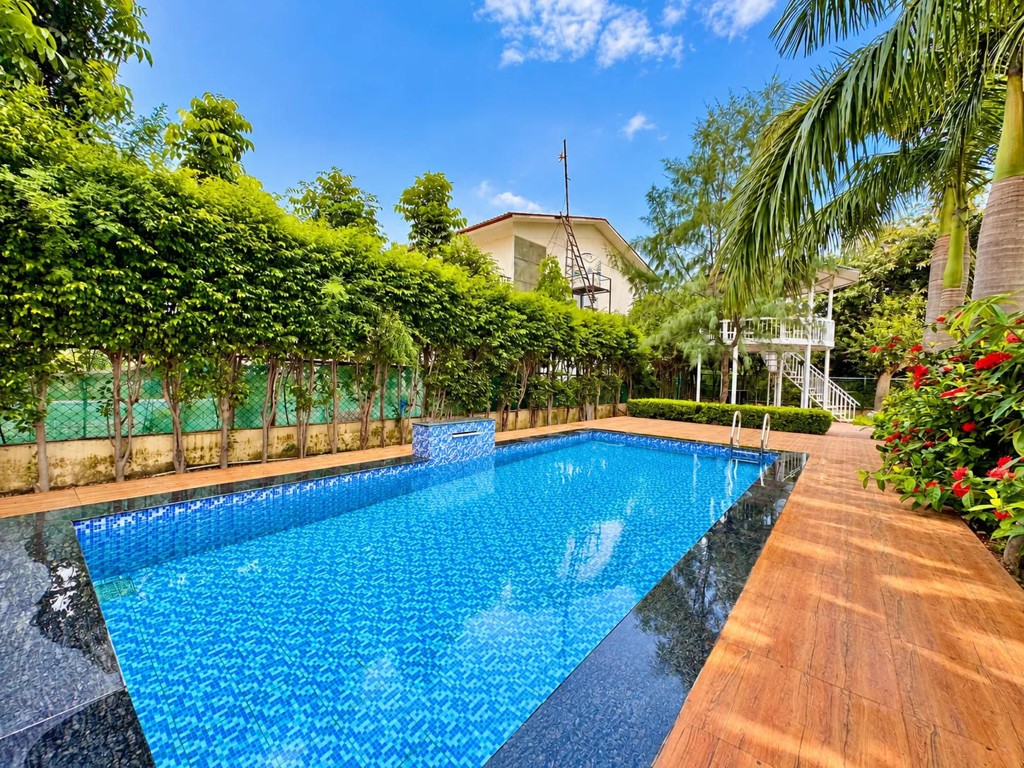 The full length of the pool at Mulberry Farm, with the house at the far end